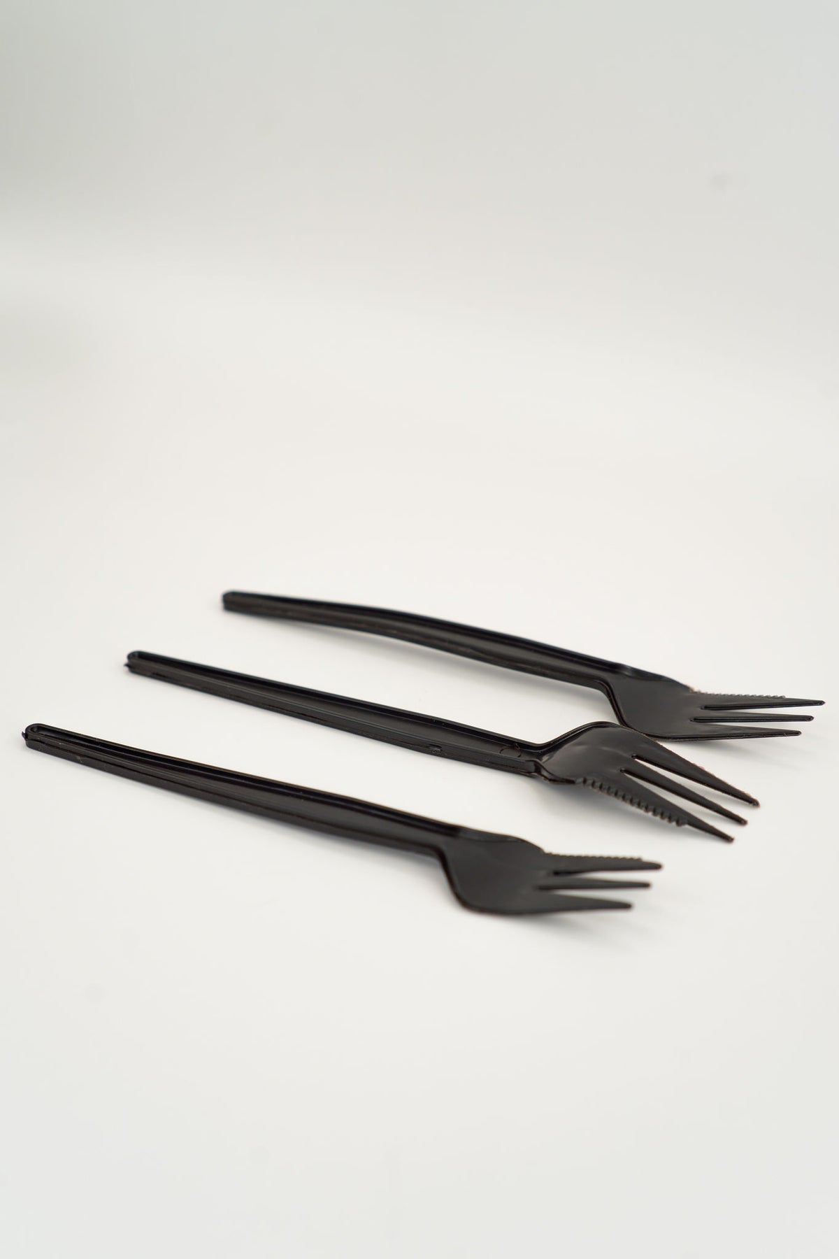 Set of three black compostable PLQ forks on a white background - Cyclups Plantastiq non-plastic cutlery made from wheat